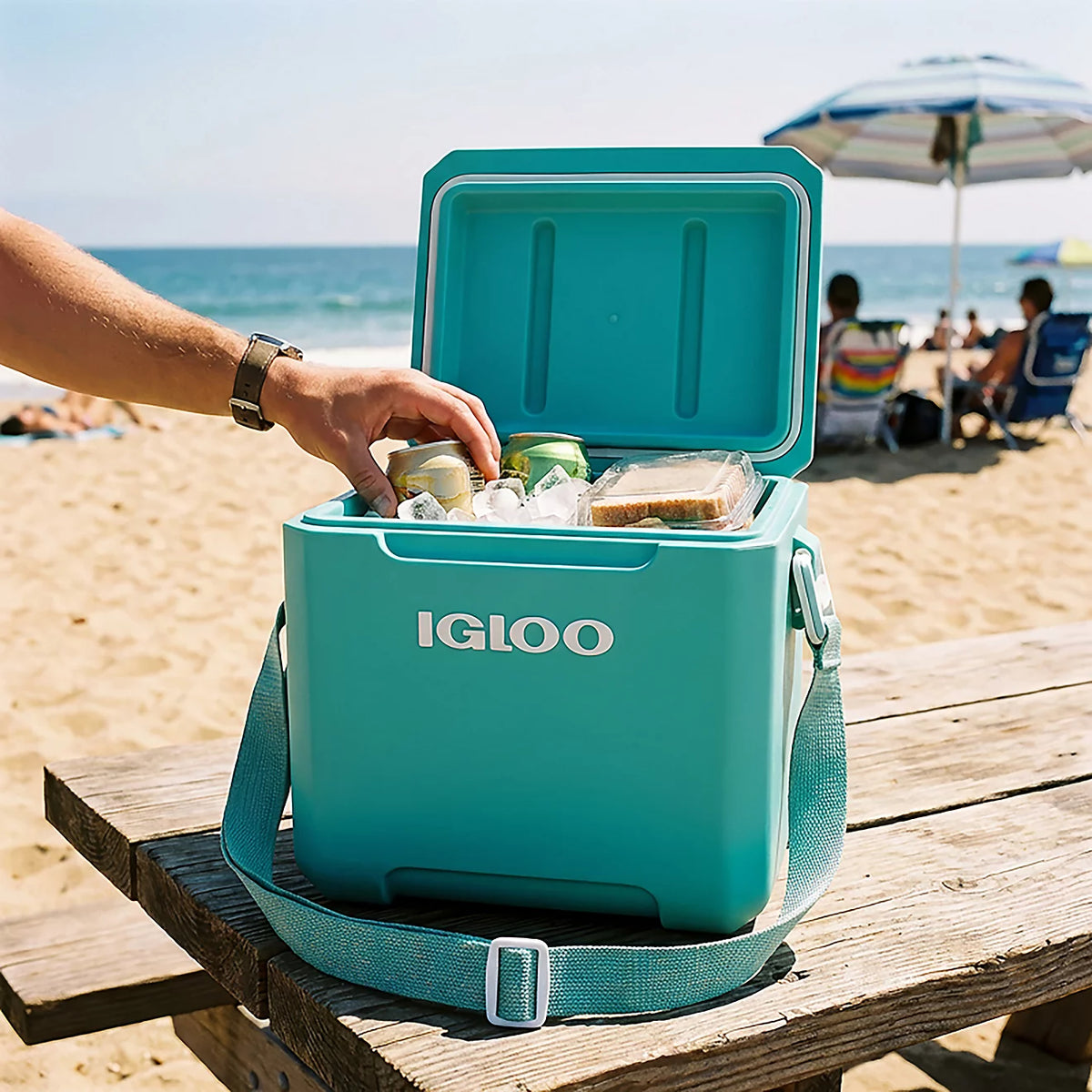 Igloo cooler packed with drinks on a beach picnic table